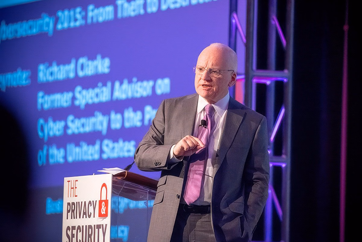 Speaker presenting at a cybersecurity conference in Boston, with a focus on corporate photography.