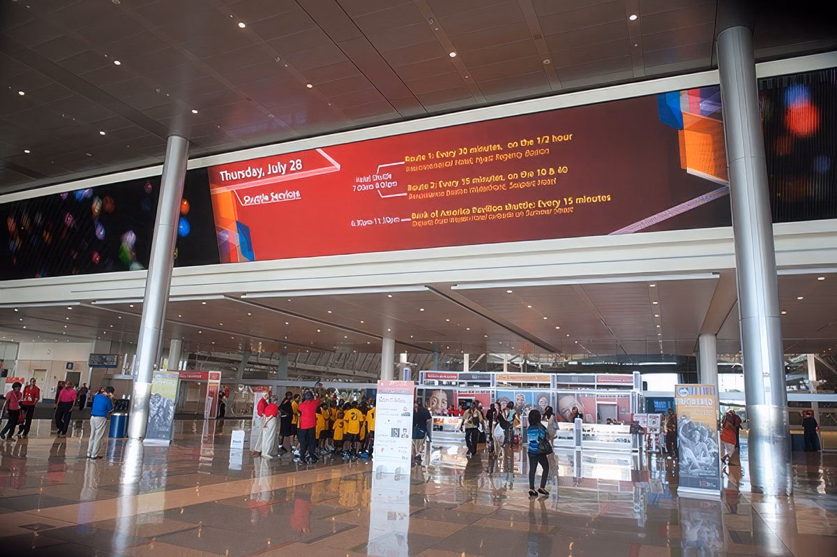 Corporate event signage inside a Boston Convention and Event Center with attendees gathered.
