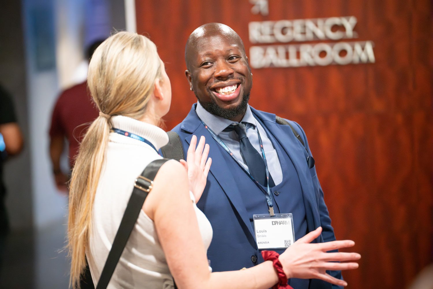 Two professionals engage in conversation at a corporate conference in Boston.