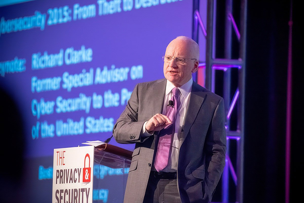 Speaker presenting at a cybersecurity conference in Boston, with a focus on corporate photography.