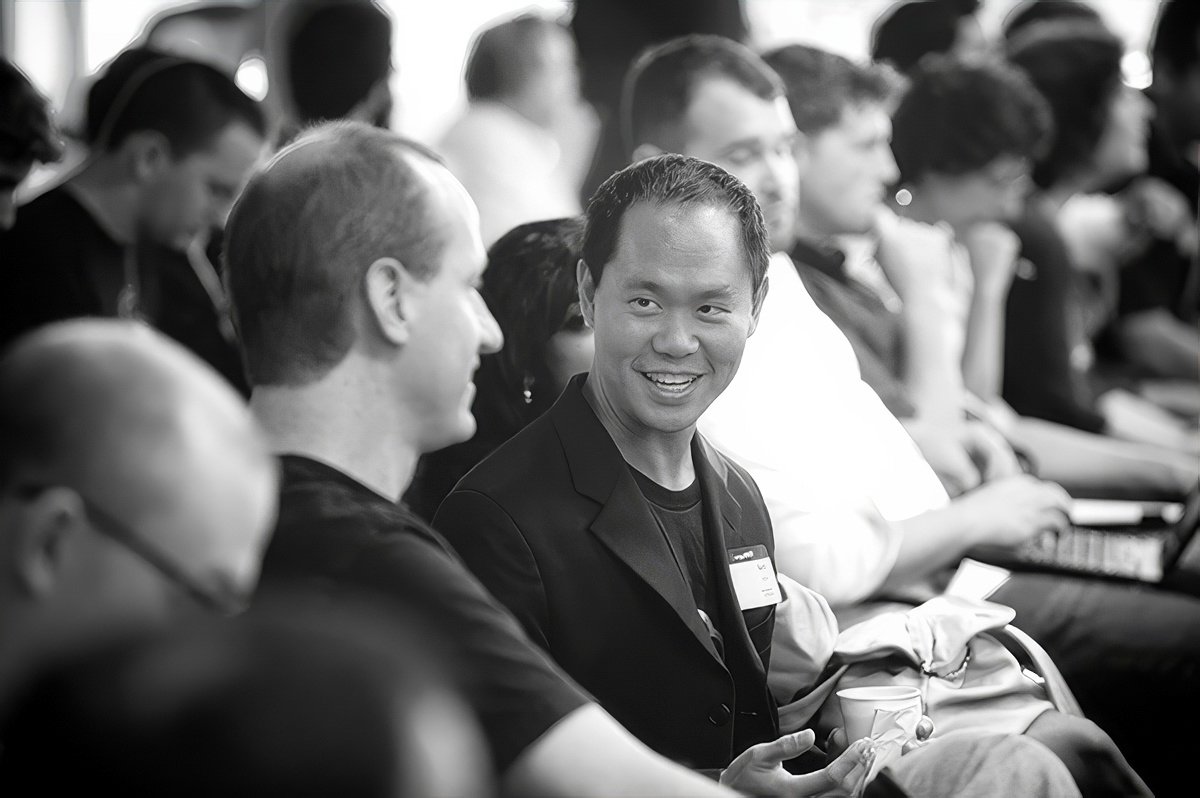 Two men engaged in conversation at a corporate event in Cambridge.