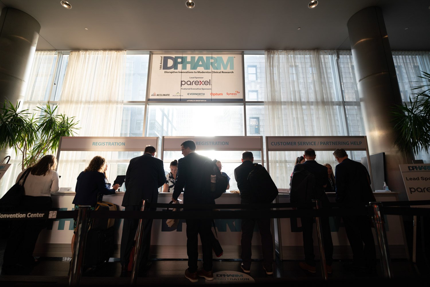 Attendees checking in at a registration desk during a corporate conference in Boston.